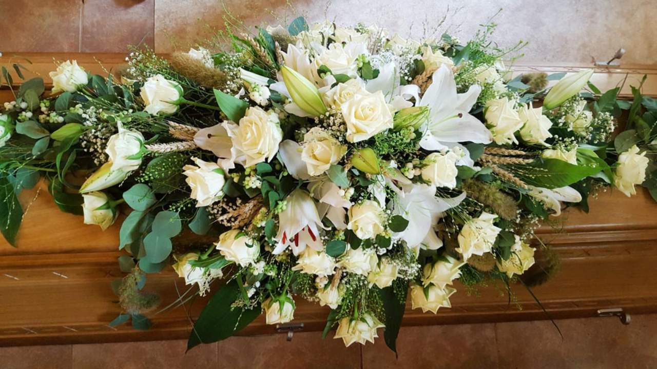 Beerdigung Blumen Olbernhau - Blütenküche Olbernhau - Foto Draufsicht Sargschmuck in Weiß mit Lilien und Rosen